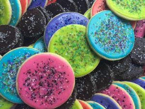 Platter of brightly colored round cookies with sugar sprinkles
