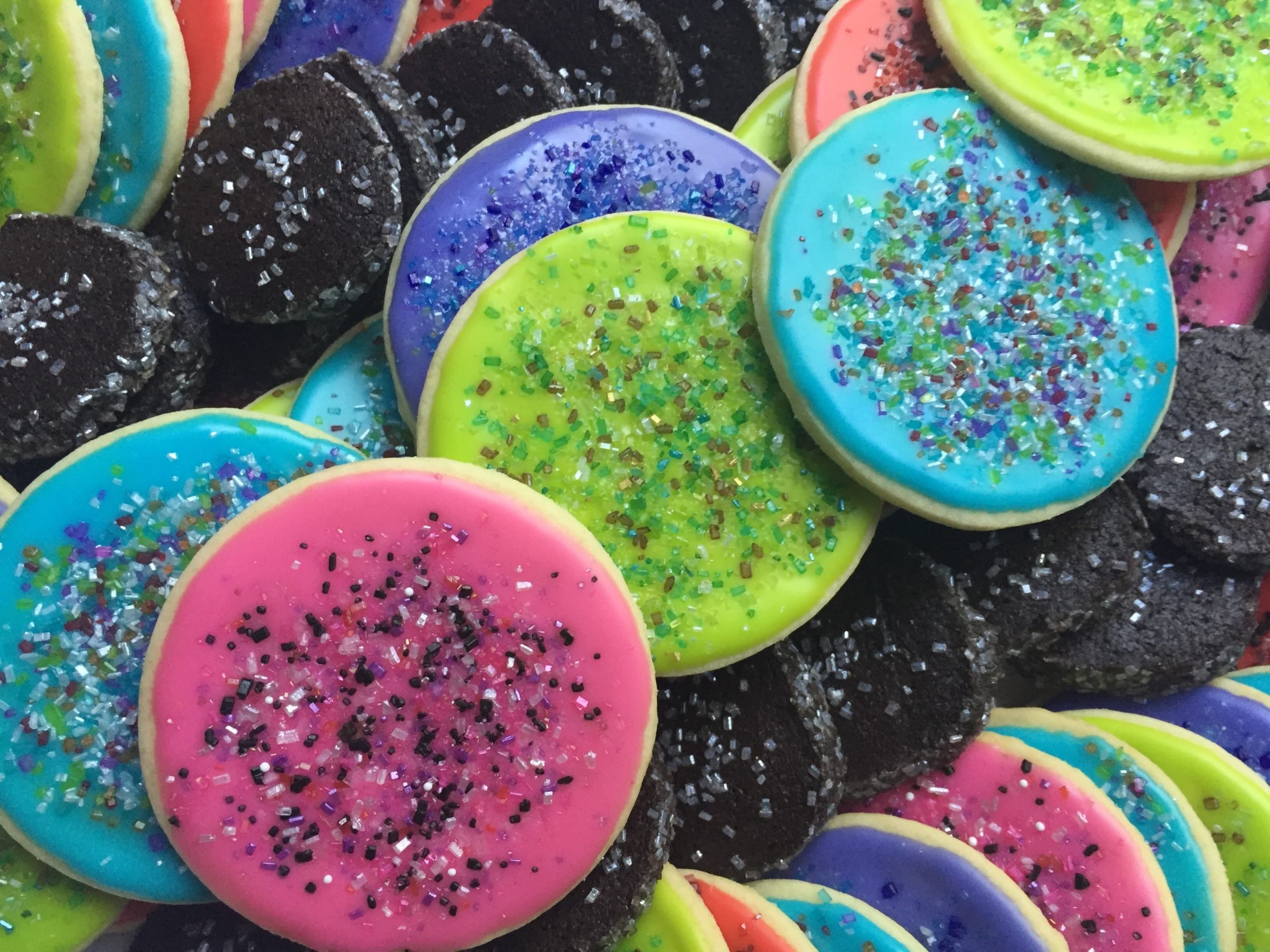 Decorated sugar cookies of bright colored circle shapes with colored sugar sprinkles