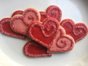 Decorated cookies of red and pink hearts with spiral sugar decoration
