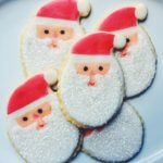 Decorated cookie of Santa head with red cap and long white beard