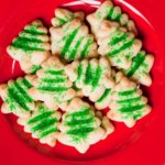 Green Christmas tree spritz cookies on red plate that inspired a home cookie business