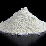 Pile of white flour on a black counter