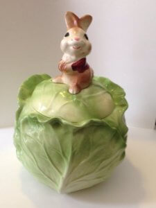 Cookie jar of bunny sitting on head of cabbage